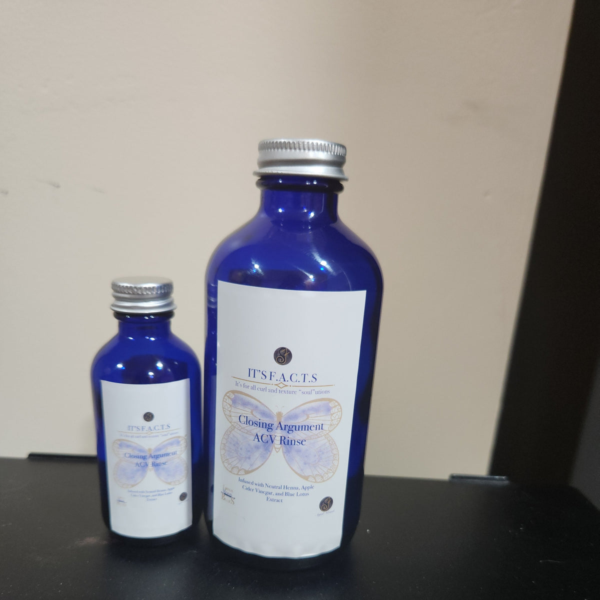 2oz and 8oz cobalt blue bottles of Closing Argument ACV rinse