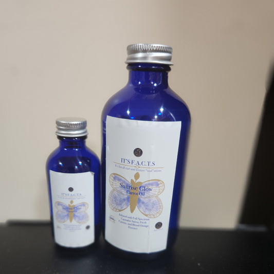 2oz and 8oz cobalt blue bottles of Sunrise glow carrot hair oil