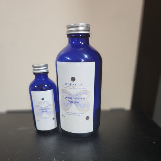 2 oz and 8 oz cobalt blue bottles of Opening Statement Shampoo